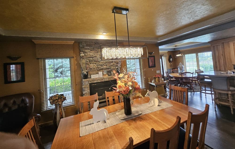 Elegant dining room with a wooden table, floral centerpiece, and decorative bunnies.